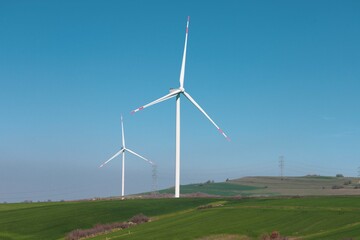 Wind turbine and windmill. Clean energy in green nature in different locations. Sustainability and environment concept
