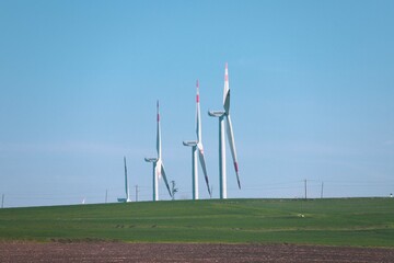 Wind turbine and windmill. Clean energy in green nature in different locations. Sustainability and...