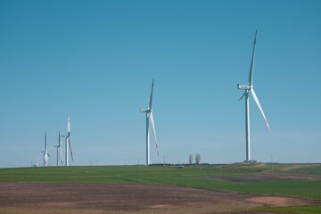 Wind turbine and windmill. Clean energy in green nature in different locations. Sustainability and environment concept  © Bigy