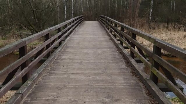 Vintage wooden bridge over a silent river. Tourism, hiking, recreation concept