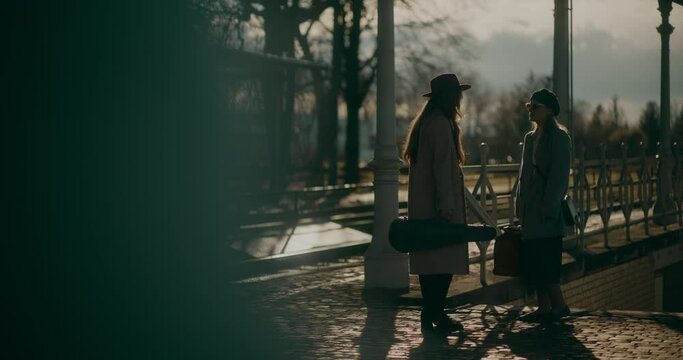 Two Women Walking at Railway Station