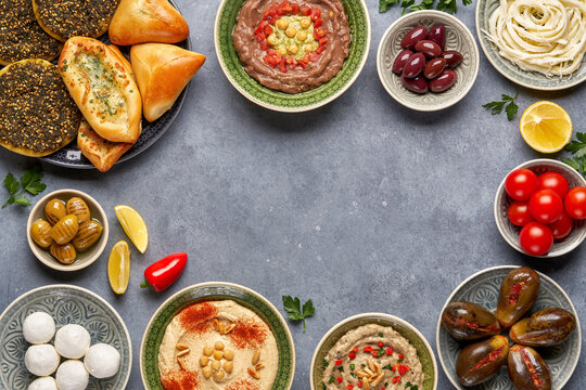 Middle eastern, arabic traditional breakfast with hummus, foul, mutabbal, makdous and zaatar. Top view with copy space