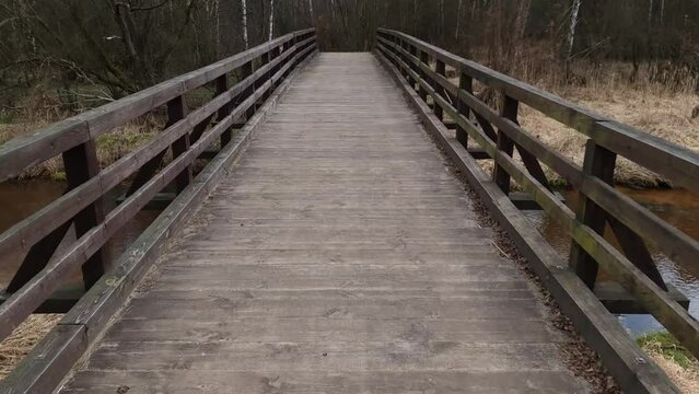 Vintage wooden bridge over a silent river. Tourism, hiking, recreation concept