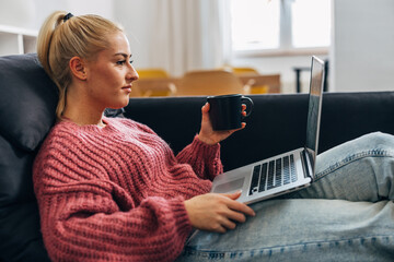 Side view of a Caucasian woman working online from home
