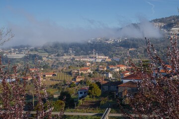 Sunny morning with hazy clouds over a picturesque valley in a village near Douro river, Portugal