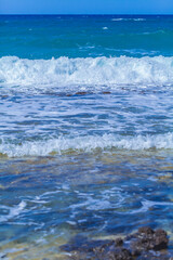 Fototapeta premium Sea waves with foam off the coast of a tropical island