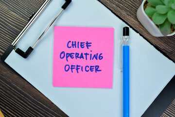 Concept of Chief Operating Officer write on sticky notes isolated on Wooden Table. - obrazy, fototapety, plakaty