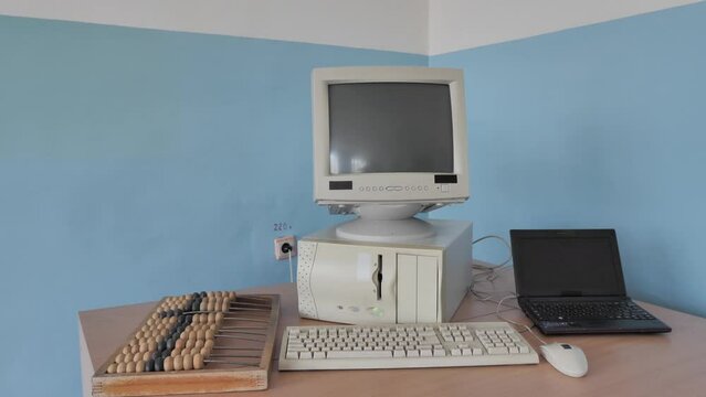 The evolution of computer technology: wooden abacus, computer, laptop
