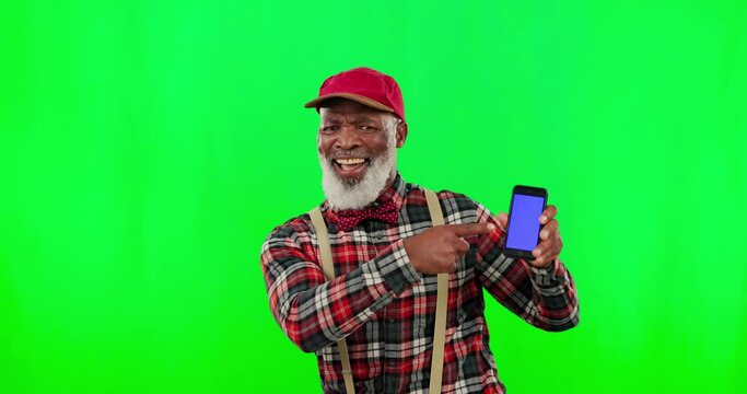 Dance, phone screen and mockup with black man pointing in green screen studio for website, text message and social media. Celebration, happy and excited with senior male on background for technology