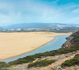 Fototapeta na wymiar Summer sandy beach Praia da Bordeira. Misty view (Carrapateira, Algarve, Portugal).