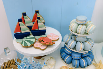 Sweets at a boy's birthday party. Cake, cupcakes, candy on blue background