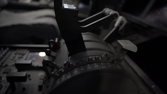 Close up of a flap handle in the cockpit of a 787 commercial aircraft being moved down and up.