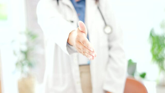 Woman, doctor and handshake for meeting, greeting or introduction for healthcare appointment at hospital. Hand of female medical professional shaking hands, emoji or sign for deal agreement at clinic
