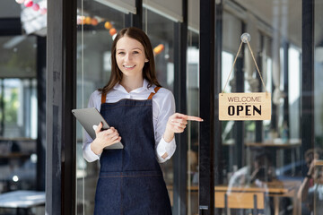 Young business woman cafe owner. Successful owner standing at cafe shop.