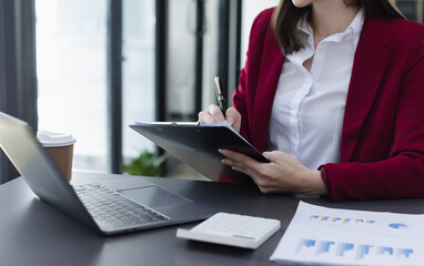 Businesswoman working and finance marketing chart, Advisor showing plan of investment to clients at table office. Digital marketing online concept.