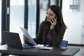 Happy excited young successful business woman and working online at the table in office, 