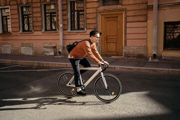 A freelance man with a briefcase is a cyclist going to work, eco transport in the city.