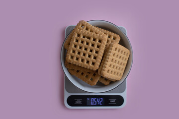 Cookies, kitchen scales on a light background