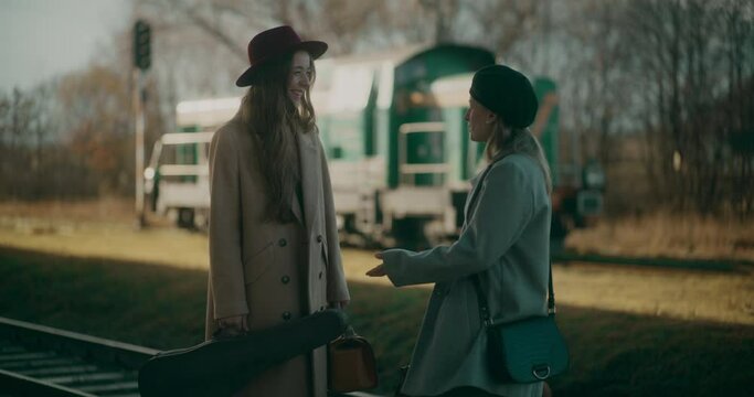 Two Women Talking at Railway Station