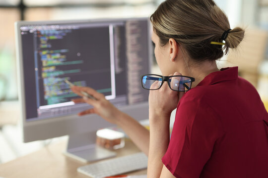 Female programmer checkups code working on computer