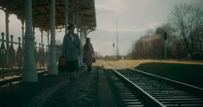 Two Women Talking at Railway Station
