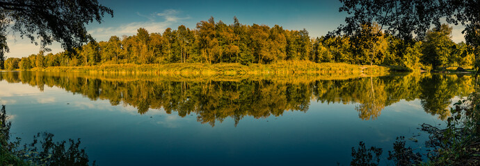 Beautiful autumn panorama of forest and reflections in the lake in Zalesie near Warsaw, Poland 