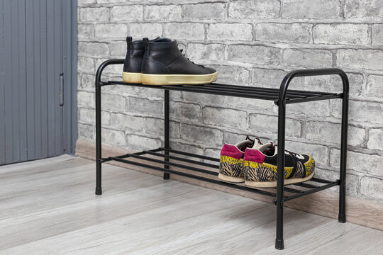 shoe rack with shoes stands in the hallway of the house