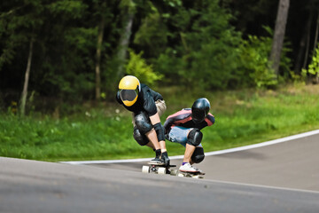 Sports, speed and safety, longboard skating in road, friends racing downhill with skateboard and...
