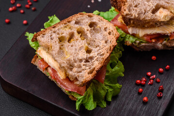 Delicious sandwich with crispy toast, chicken, tomatoes and lettuce