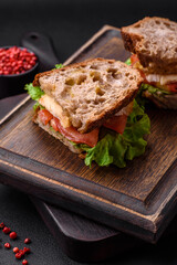 Delicious sandwich with crispy toast, chicken, tomatoes and lettuce