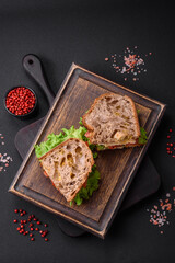 Delicious sandwich with crispy toast, chicken, tomatoes and lettuce
