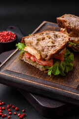 Delicious sandwich with crispy toast, chicken, tomatoes and lettuce