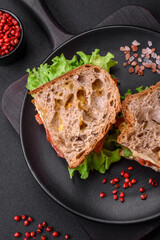 Delicious sandwich with crispy toast, chicken, tomatoes and lettuce