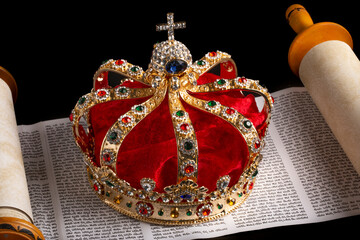 A Gold Coronation Crown with Red Velevet on a Bible on an Open Hebrew Scroll