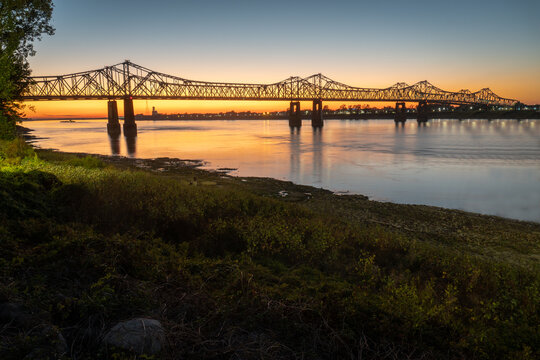 Sunset on the Mississippi River in Natchez, Mississippi with the Natchez Vidalia Bridge.