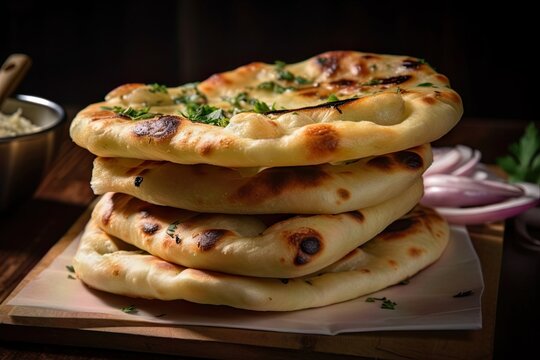 freshly baked nan and garlic bread on a tray with perfect doneness