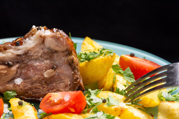 Baked pork knuckle with potatoes and vegetables