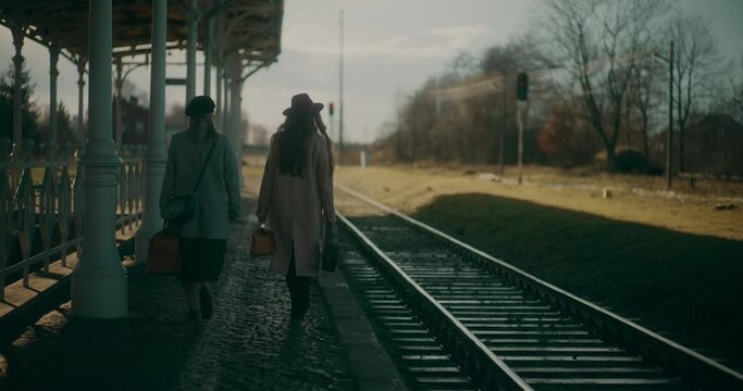 Two Women Walking at Railway Station
