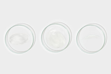 A set of Petri dishes with smeared gel in different shapes. View from above