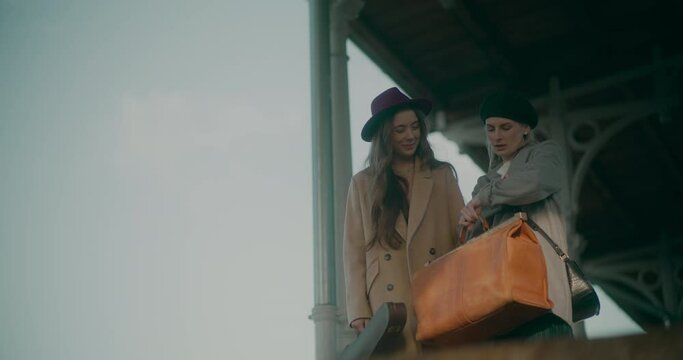 Two Women Talking at Railway Station