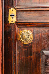 Brass knob on a wooden door.