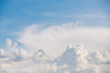 White fluffy clouds in light blue sky. Sky background with clouds