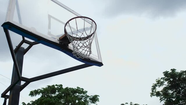 the ball hits the basketball hoop in the park