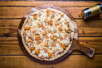 Cheesy Overloaded Pizza isolated on wooden board top view on table fastfood