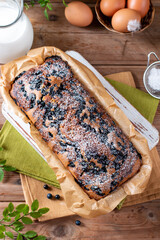 Bread, sliced cake with blueberries. Morning breakfast on wooden table