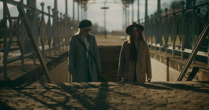 Two Women Walking at Railway Station