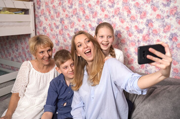 Happy woman takes selfie with kids and grandma