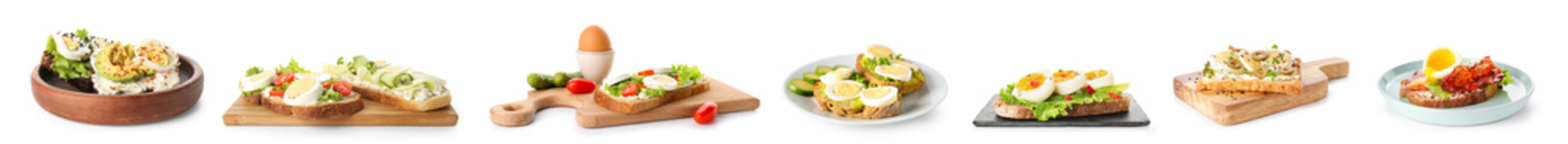 Set of tasty toasts with boiled eggs on white background