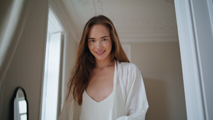 Naklejka premium Cheerful model walking morning apartment alone. Positive girl looking camera