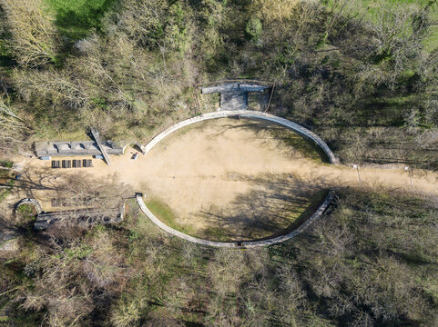 Kaiseraugst, Switzerland - March 28. 2023: Aerial drone view over the ancient Roman amphitheater ruins at Augusta Raurica in Kaiseraugst. It was founded by Lucius Munatius Plancus around 44 BC